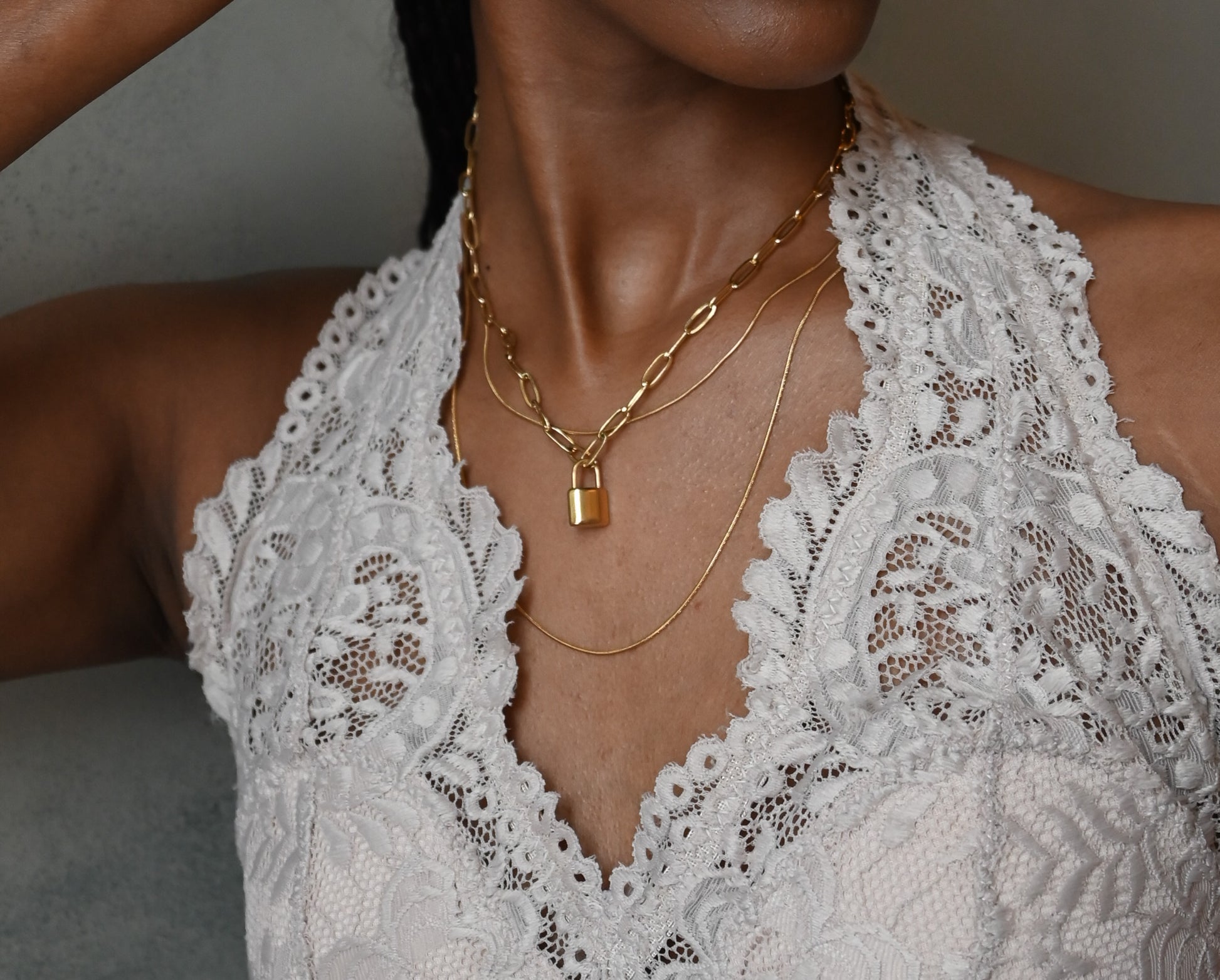 model wearing paperclip chain with padlock accent in gold