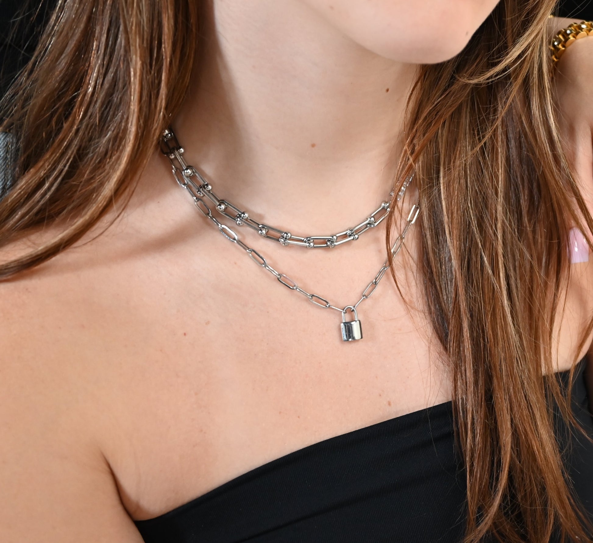 model wearing paperclip chain with padlock accent in silver