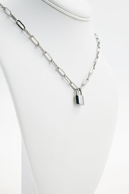 silver paperclip chain with padlock accent on manequin 