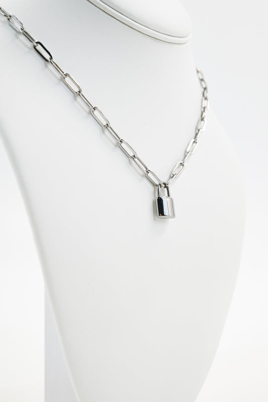 silver paperclip chain with padlock accent on manequin 