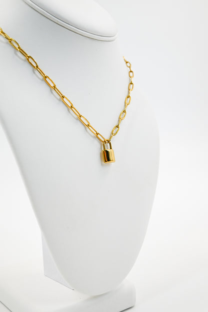 gold paper clip chain with padlock accent on mannequin 