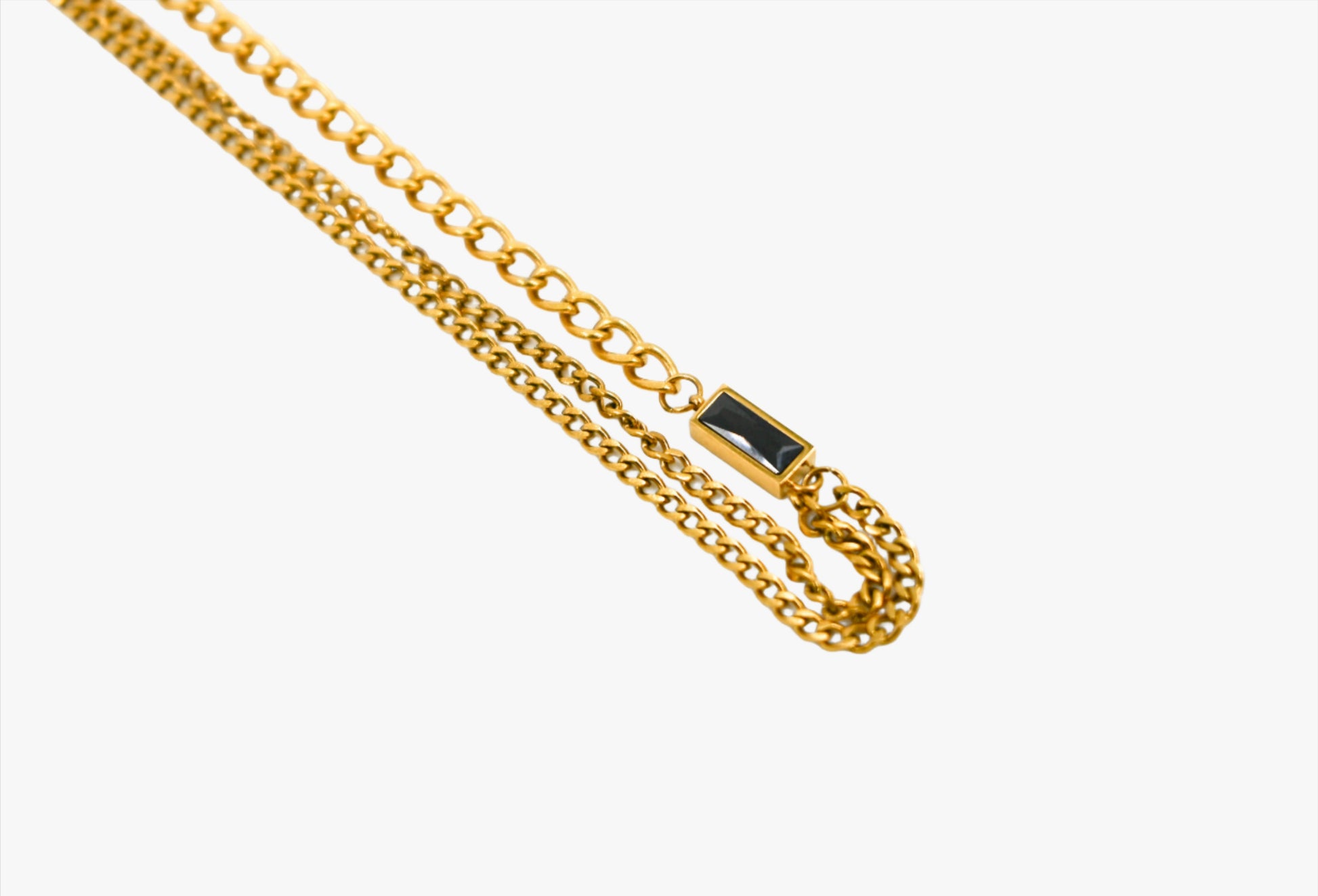 gold chain with black stone accent