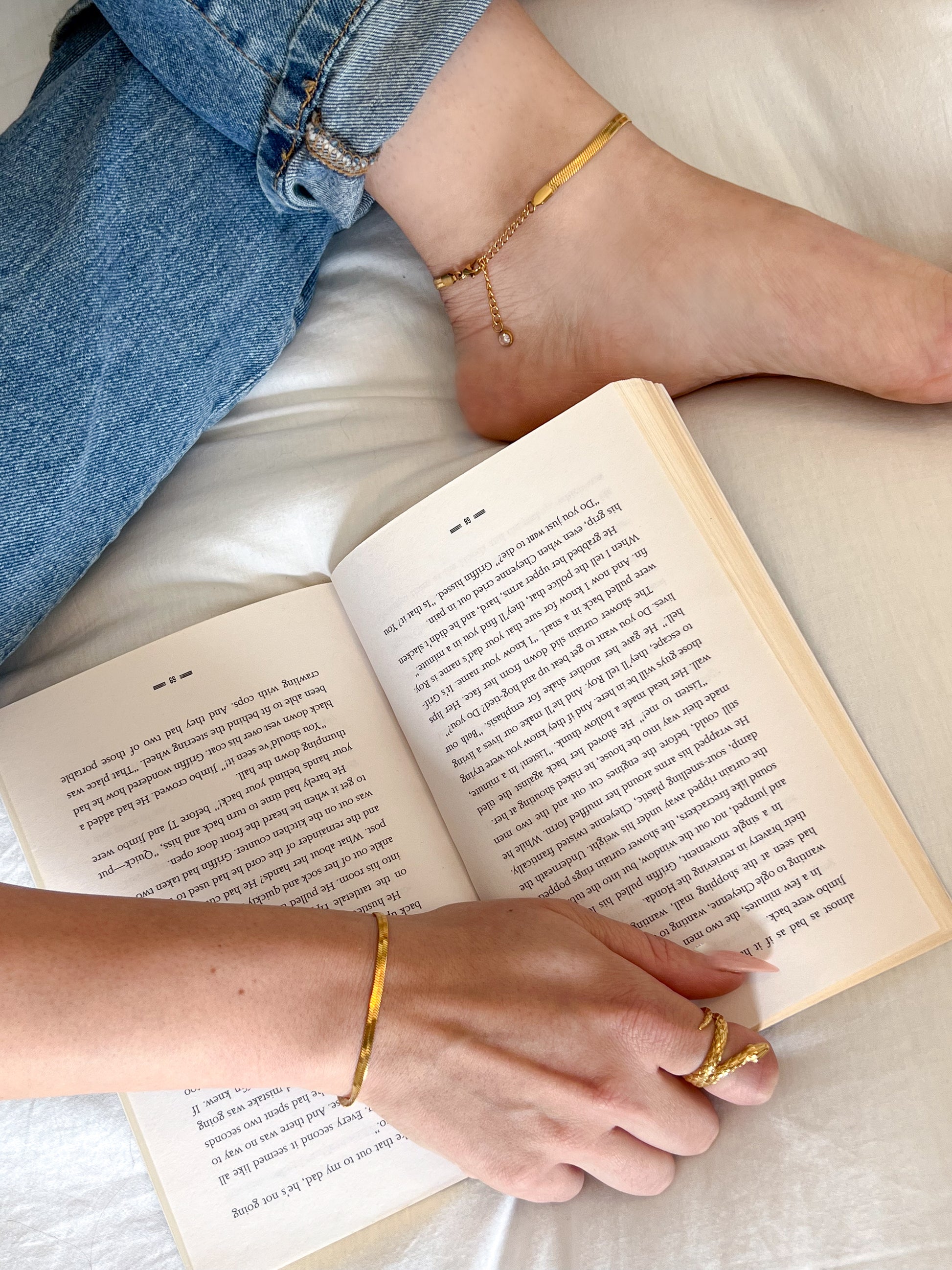 picture of girl reading a book with anklet on her ankle